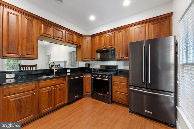 2619 Sledding Hill Rd, Oakton, VA 22124 - kitchen featuring light wood-type flooring, a sink, brown cabinetry, and appliances with stainless steel finishes