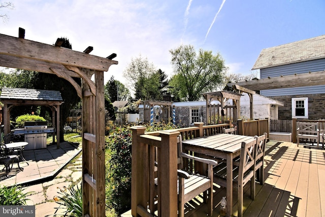 deck featuring a pergola and outdoor dining area