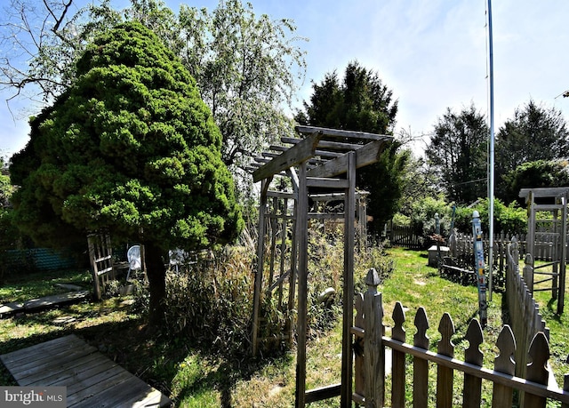 view of yard with fence and a pergola