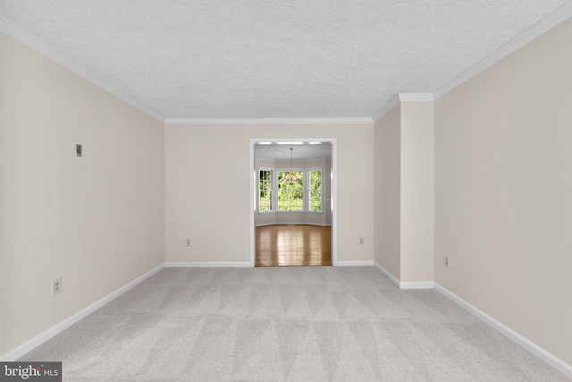 unfurnished room featuring a textured ceiling, light carpet, baseboards, and ornamental molding