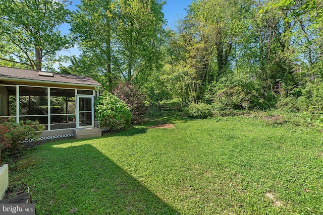 view of yard featuring a sunroom