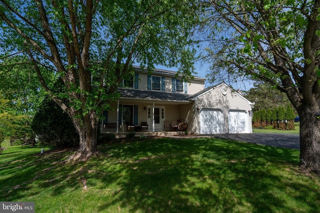 1069 E 2nd St, Red Hill, PA 18076 - traditional home with a porch, a garage, a front lawn, and driveway