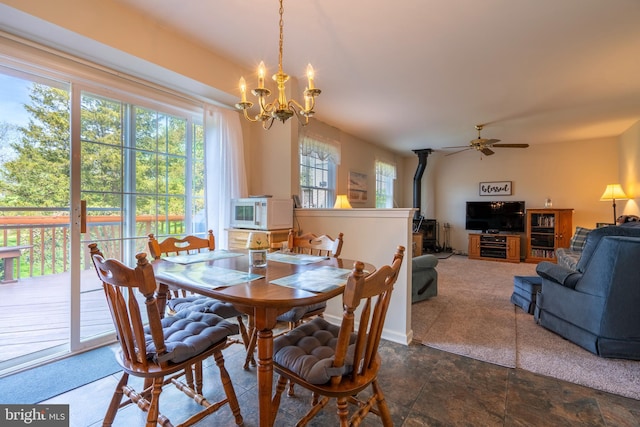 1069 E 2nd St, Red Hill, PA 18076 - dining space featuring a wood stove, ceiling fan with notable chandelier, and stone finish floor