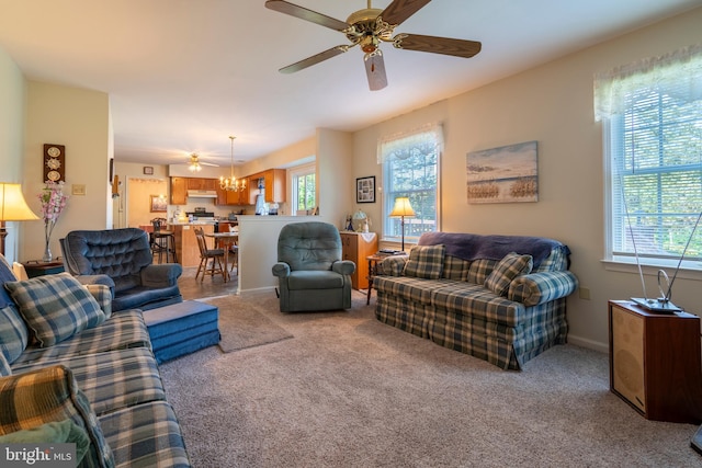 1069 E 2nd St, Red Hill, PA 18076 - living area with baseboards, light carpet, and ceiling fan with notable chandelier
