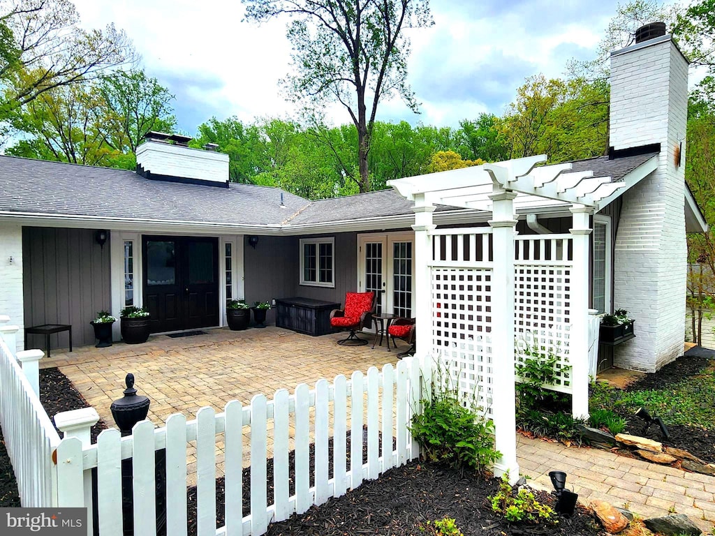 9003 Manordale Ln, Ellicott City, MD 21042 - view of front facade with fence private yard, french doors, a chimney, a patio area, and a jacuzzi