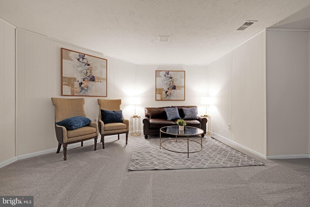 9120 Galbreth Ct, Springfield, VA 22153 - sitting room featuring carpet floors, a textured ceiling, baseboards, and a decorative wall