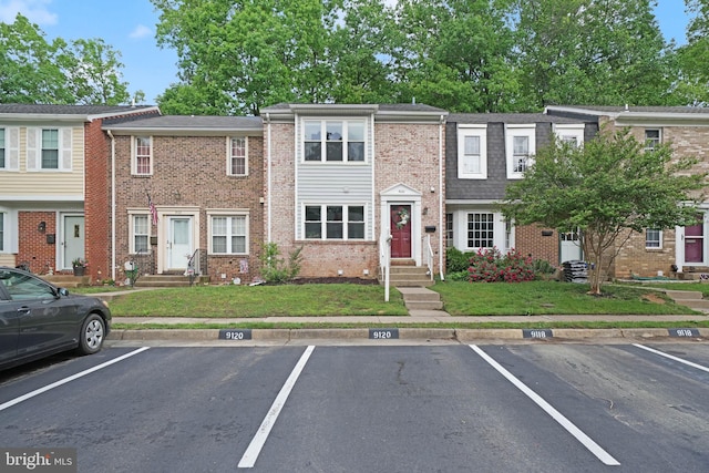 9120 Galbreth Ct, Springfield, VA 22153 - multi unit property featuring uncovered parking, brick siding, and a front lawn