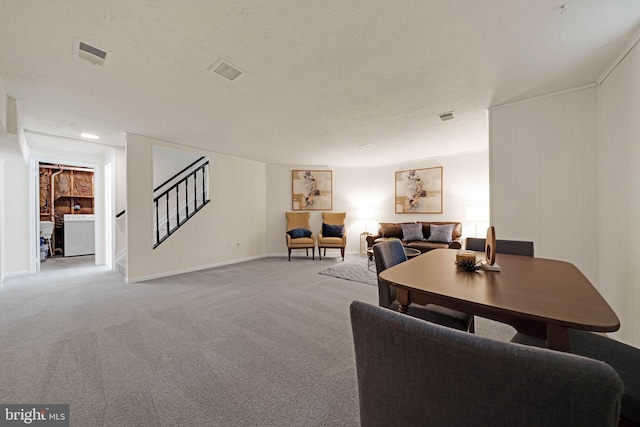 9120 Galbreth Ct, Springfield, VA 22153 - living area featuring stairs, light carpet, washer / dryer, a textured ceiling, and baseboards