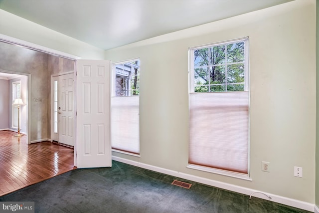 carpeted spare room featuring baseboards