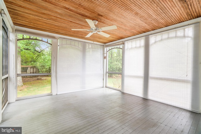 unfurnished sunroom featuring ceiling fan and healthy amount of natural light