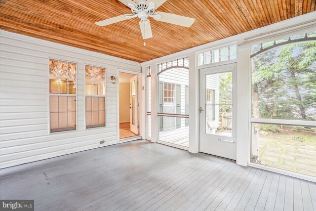 unfurnished sunroom with a ceiling fan