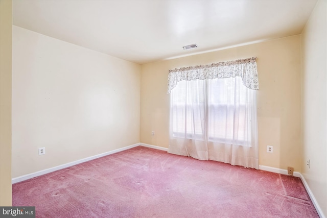 carpeted spare room with baseboards