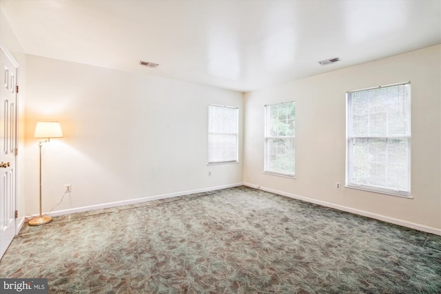 spare room with carpet and baseboards