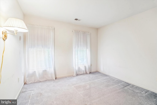 carpeted empty room with baseboards