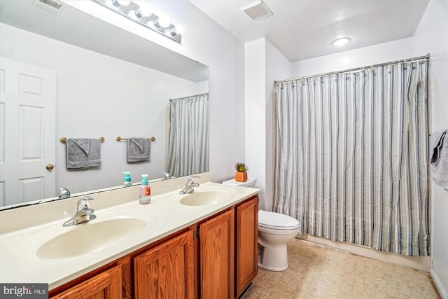 bathroom featuring toilet, double vanity, and a shower with curtain