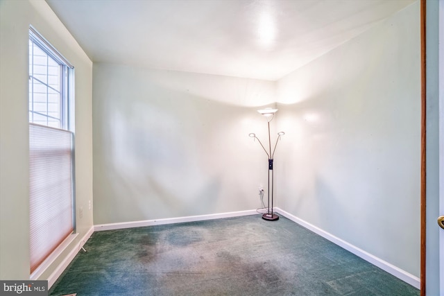 carpeted empty room with baseboards
