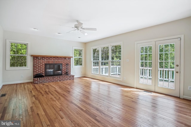 unfurnished living room with baseboards, a ceiling fan, hardwood / wood-style flooring, and visible vents