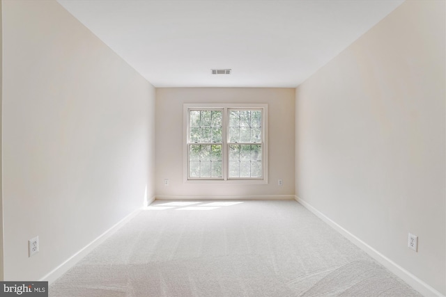 spare room featuring baseboards, carpet, and visible vents