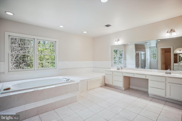 full bathroom featuring vanity, tile patterned floors, and a bath
