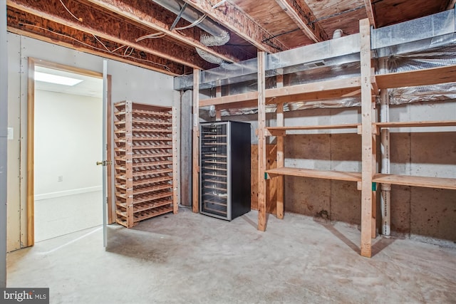 unfinished basement featuring beverage cooler