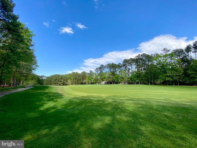 view of home's community with a lawn and golf course view