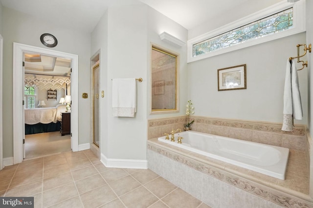 full bath with tile patterned floors, plenty of natural light, a garden tub, and ensuite bath