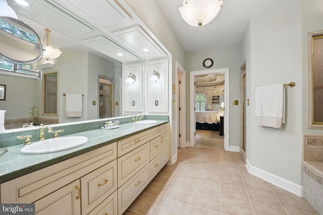 full bath featuring a sink, tile patterned floors, a stall shower, and ensuite bath