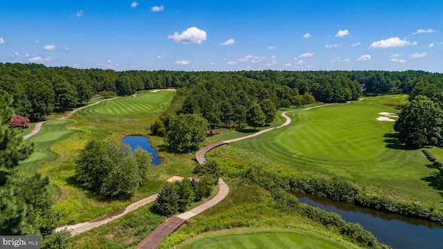 birds eye view of property featuring a water view, view of golf course, and a forest view