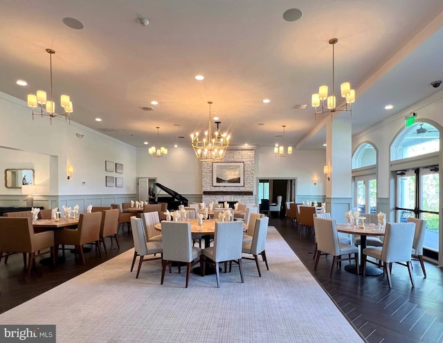 dining space with a wainscoted wall, a decorative wall, recessed lighting, and a chandelier