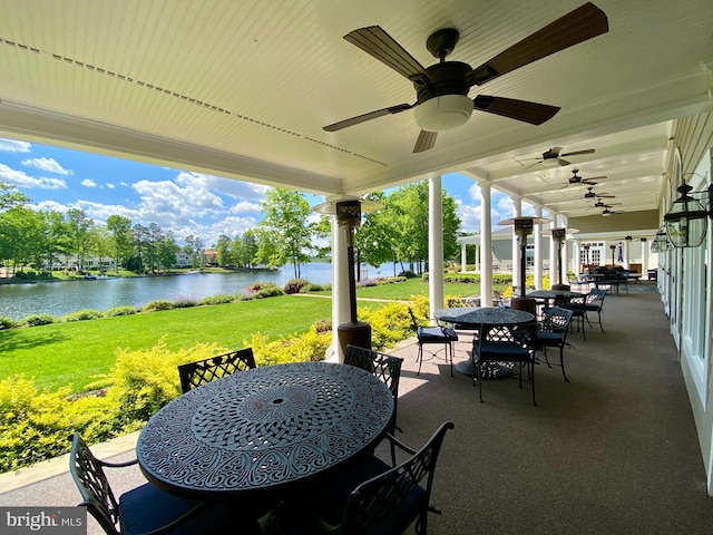 view of patio / terrace with a water view, ceiling fan, and outdoor dining area