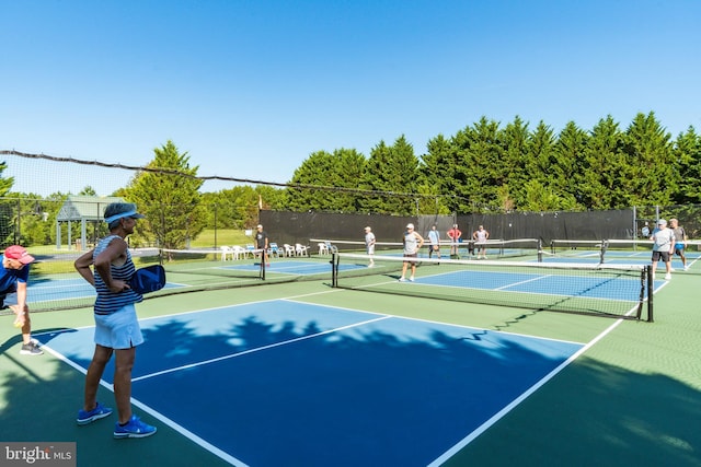 view of tennis court featuring fence