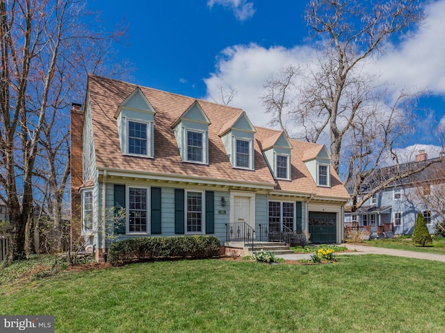 112 E Jefferson St E, Falls Church, VA 22046 - new england style home with a chimney, driveway, a front lawn, and a garage