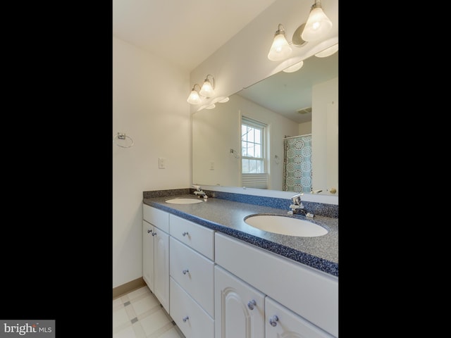 112 E Jefferson St E, Falls Church, VA 22046 - bathroom with double vanity and baseboards