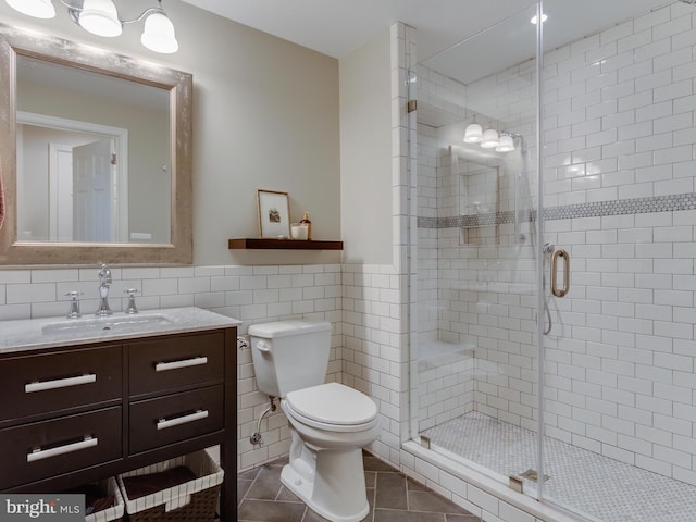112 E Jefferson St E, Falls Church, VA 22046 - bathroom with tile walls, vanity, toilet, a shower stall, and tile patterned flooring