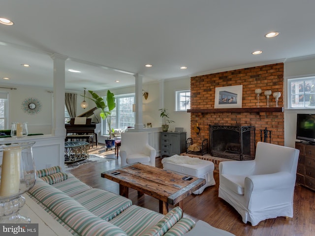 112 E Jefferson St E, Falls Church, VA 22046 - living room featuring decorative columns, a brick fireplace, wood finished floors, ornamental molding, and recessed lighting