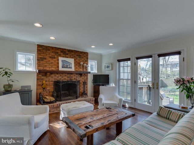 112 E Jefferson St E, Falls Church, VA 22046 - living room with ornamental molding, wood finished floors, french doors, a brick fireplace, and recessed lighting