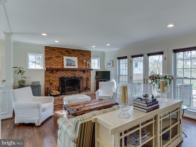 112 E Jefferson St E, Falls Church, VA 22046 - living area with ornamental molding, plenty of natural light, wood finished floors, a brick fireplace, and recessed lighting