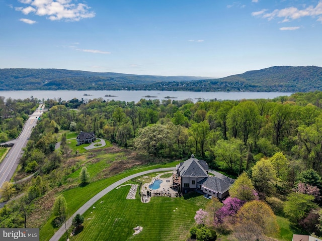 aerial view with a forest view and a water and mountain view