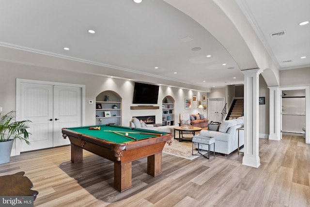 360 Fishing Creek Valley Rd, Harrisburg, PA 17112 - game room featuring crown molding, ornate columns, a warm lit fireplace, light wood finished floors, and built in features