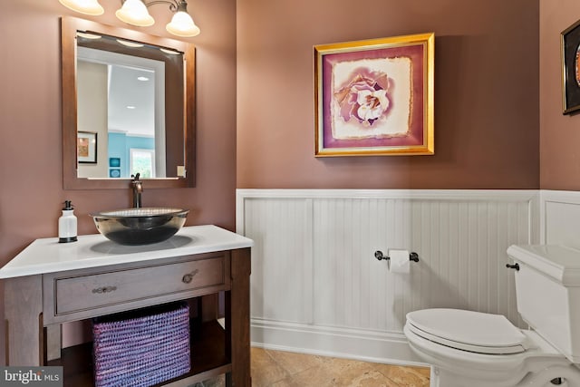 360 Fishing Creek Valley Rd, Harrisburg, PA 17112 - half bathroom with a wainscoted wall, toilet, and vanity