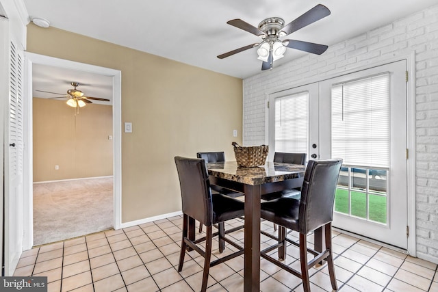 15700 Presswick Ln, Bowie, MD 20716 - dining space featuring light colored carpet, light tile patterned flooring, brick wall, french doors, and a ceiling fan