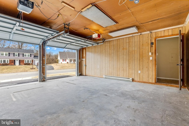 15700 Presswick Ln, Bowie, MD 20716 - garage featuring a baseboard heating unit, wood walls, and a garage door opener
