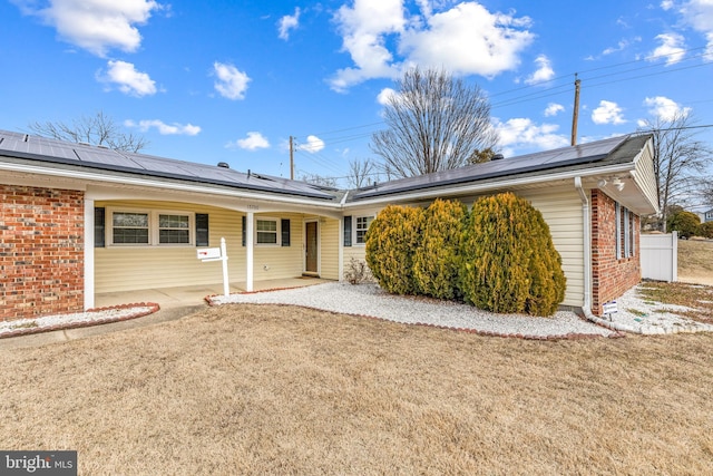 15700 Presswick Ln, Bowie, MD 20716 - rear view of property featuring a lawn, solar panels, and brick siding