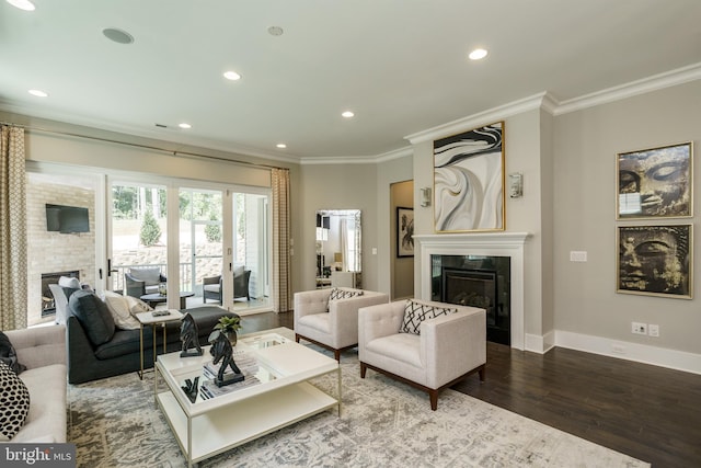 living room with ornamental molding, baseboards, wood finished floors, and a glass covered fireplace