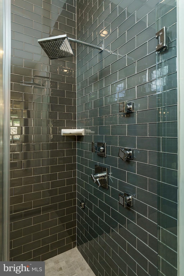 full bathroom with a tile shower