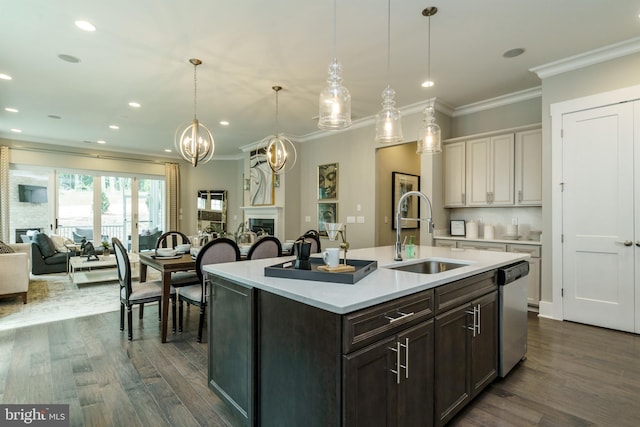 kitchen featuring stainless steel dishwasher, a sink, light countertops, dark wood-style floors, and open floor plan