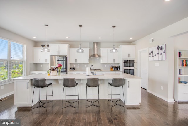 5510 Woodyard Rd, Upper Marlboro, MD 20772 - kitchen featuring wall chimney exhaust hood, stainless steel appliances, a spacious island, baseboards, and recessed lighting