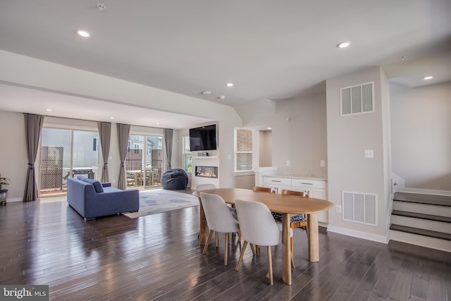 5510 Woodyard Rd, Upper Marlboro, MD 20772 - dining room with dark wood-type flooring, stairway, a glass covered fireplace, baseboards, and recessed lighting