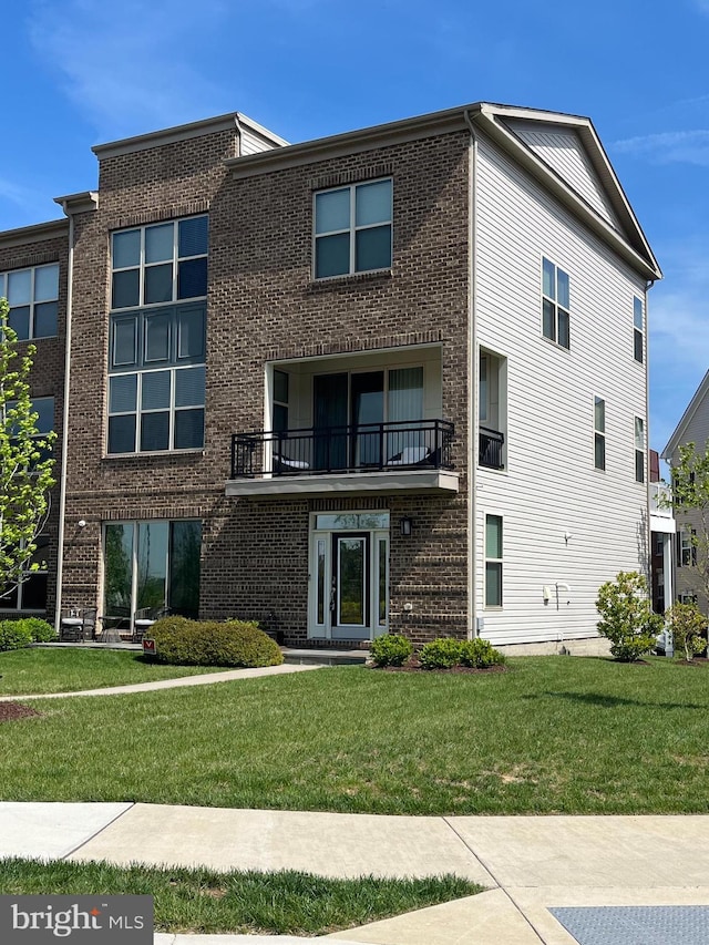 5510 Woodyard Rd, Upper Marlboro, MD 20772 - view of front of house featuring a front lawn, brick siding, and a balcony