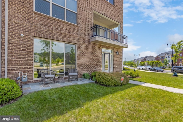 5510 Woodyard Rd, Upper Marlboro, MD 20772 - rear view of property featuring brick siding, a lawn, a balcony, and a patio
